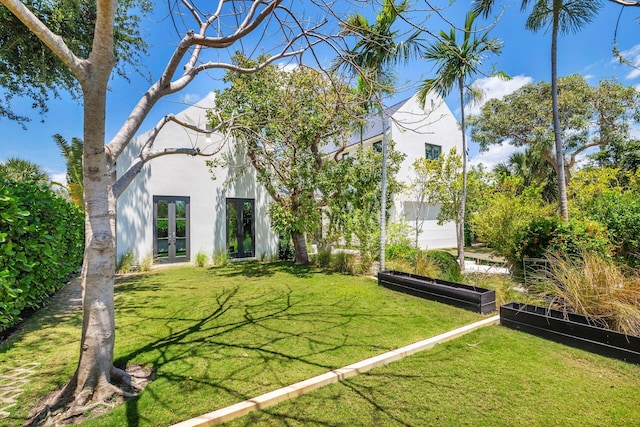 view of yard featuring french doors