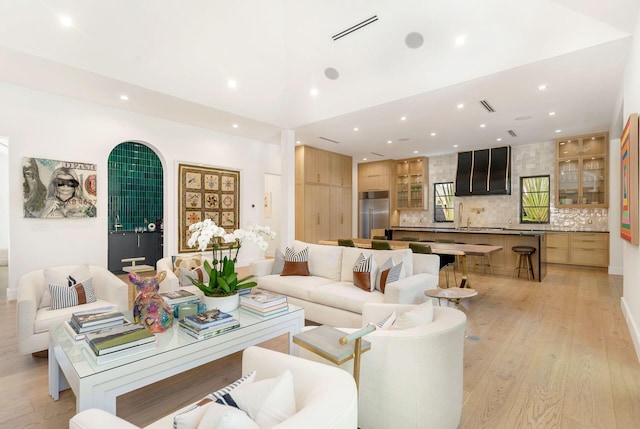 living room featuring sink and light wood-type flooring