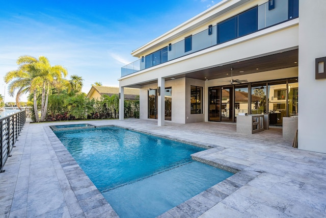 view of swimming pool with a patio and ceiling fan