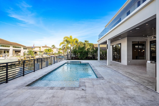 view of pool featuring a fenced in pool, a patio area, fence, and ceiling fan
