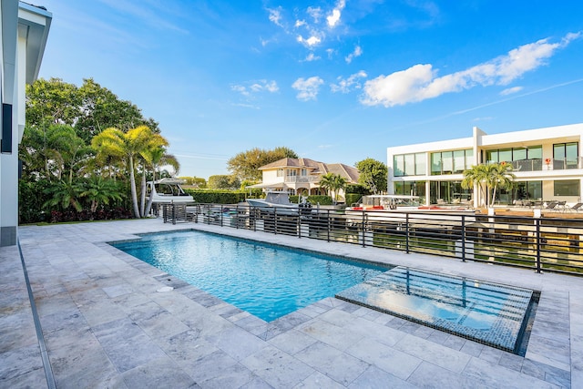 view of swimming pool with a patio