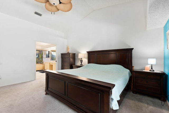 bedroom featuring ensuite bath, ceiling fan, light colored carpet, and a textured ceiling