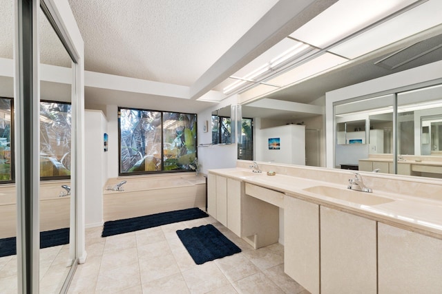 bathroom with tile patterned flooring, vanity, and a textured ceiling