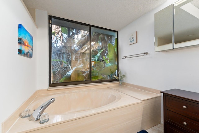 bathroom featuring a tub to relax in and a textured ceiling