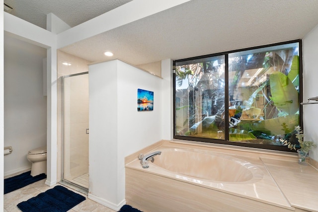 bathroom featuring separate shower and tub, tile patterned flooring, a textured ceiling, and toilet