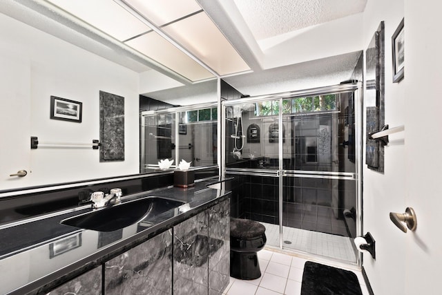 bathroom with tile patterned floors, a textured ceiling, an enclosed shower, and toilet