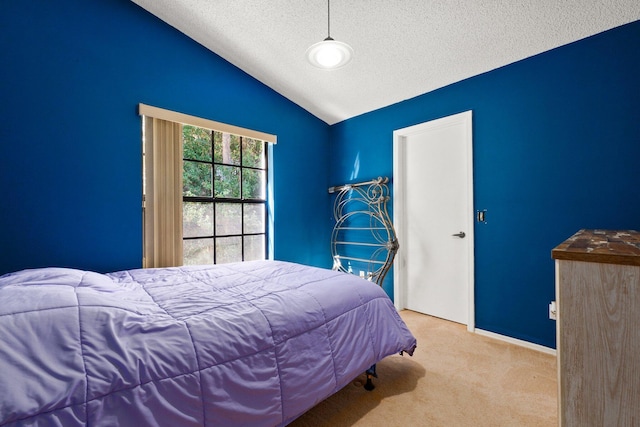 bedroom featuring light colored carpet, lofted ceiling, and a textured ceiling