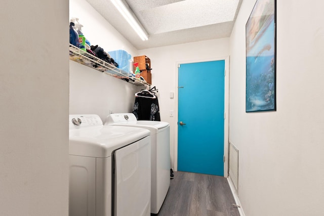 laundry area featuring hardwood / wood-style floors and washing machine and clothes dryer