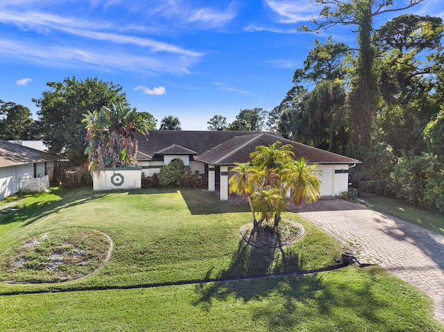 ranch-style home with a front yard and a garage