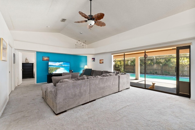 living room with ceiling fan, light colored carpet, and lofted ceiling