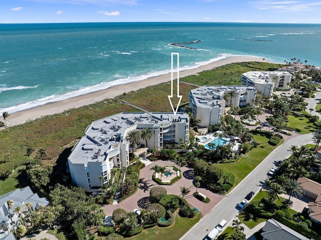 birds eye view of property featuring a water view and a beach view