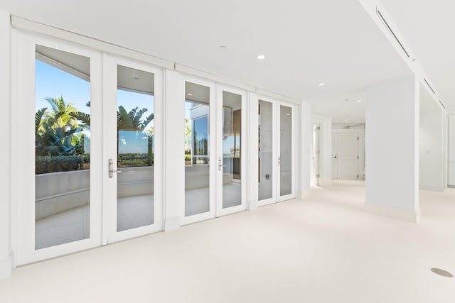 interior space with french doors and light colored carpet