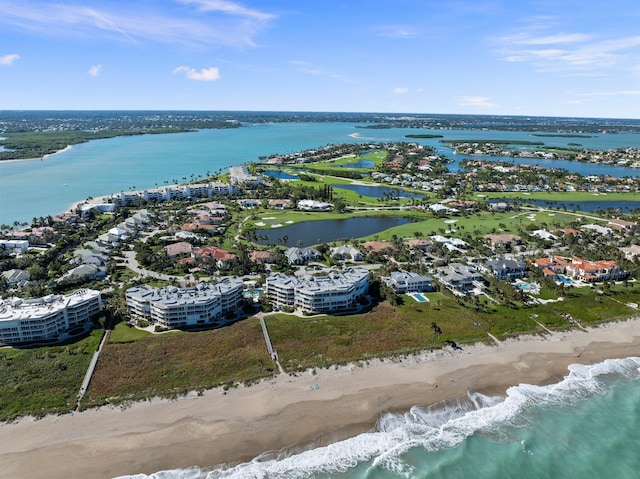 birds eye view of property featuring a view of the beach and a water view