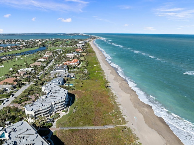 birds eye view of property with a beach view and a water view