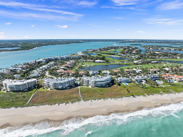 bird's eye view with a water view and a beach view