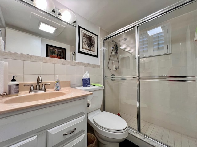 bathroom featuring vanity, decorative backsplash, toilet, tile walls, and an enclosed shower