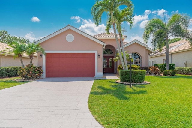 view of front of house featuring a front yard and a garage