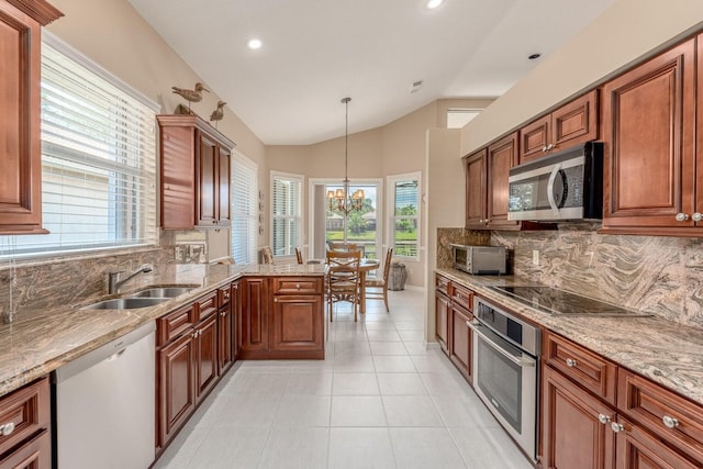 kitchen with pendant lighting, sink, stainless steel appliances, and a wealth of natural light