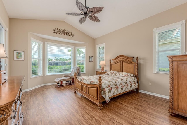 bedroom with hardwood / wood-style flooring, vaulted ceiling, and ceiling fan