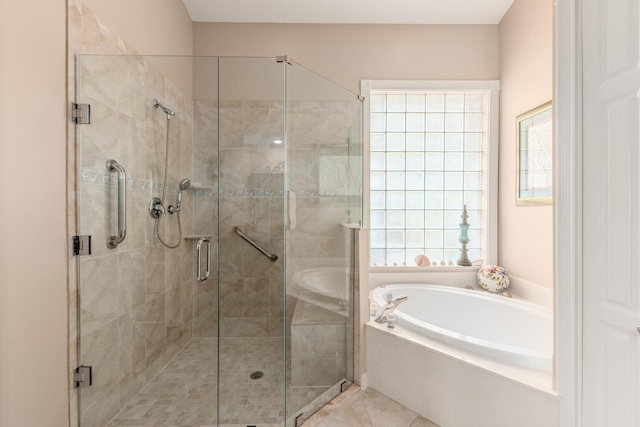 bathroom featuring shower with separate bathtub