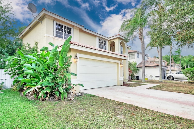 mediterranean / spanish-style home with a front yard and a garage