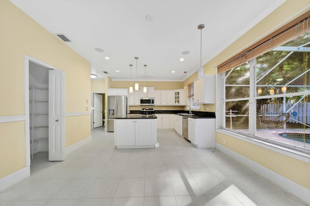 kitchen with white cabinets, sink, hanging light fixtures, ornamental molding, and appliances with stainless steel finishes