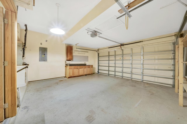 garage with electric panel and a garage door opener