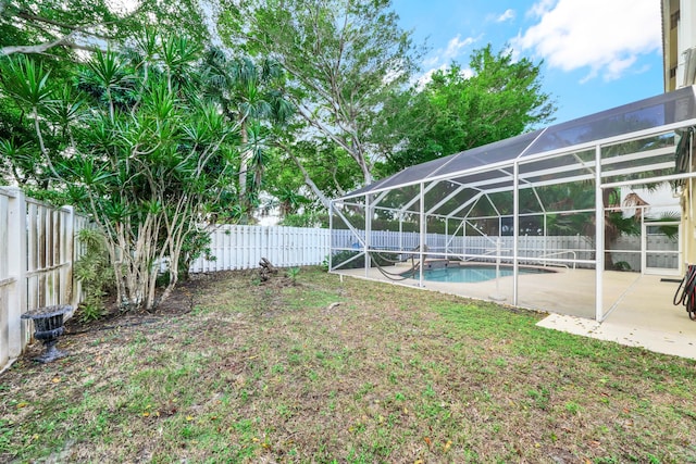 view of yard featuring a lanai, a patio, and a fenced in pool