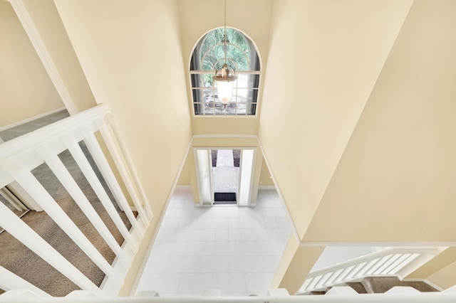 interior space featuring a high ceiling and an inviting chandelier