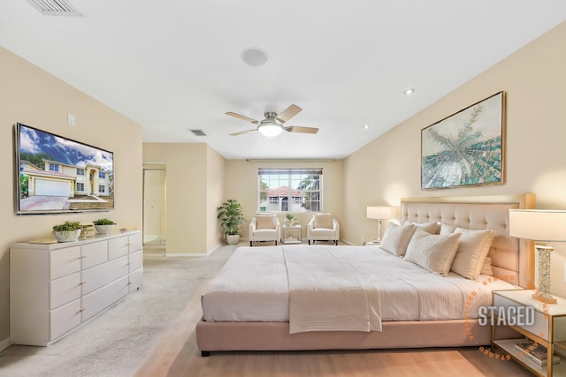 bedroom with ceiling fan and light colored carpet