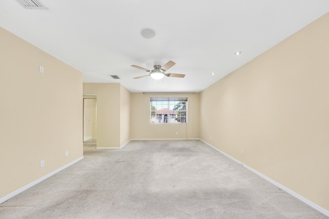 spare room featuring ceiling fan and light colored carpet