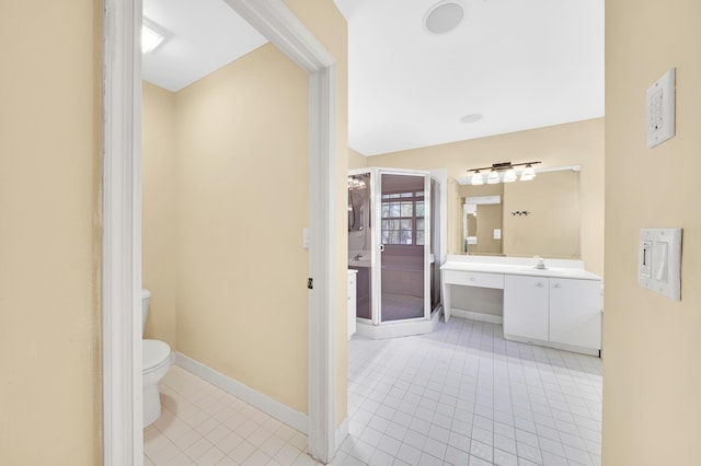 bathroom featuring tile patterned flooring, vanity, and toilet