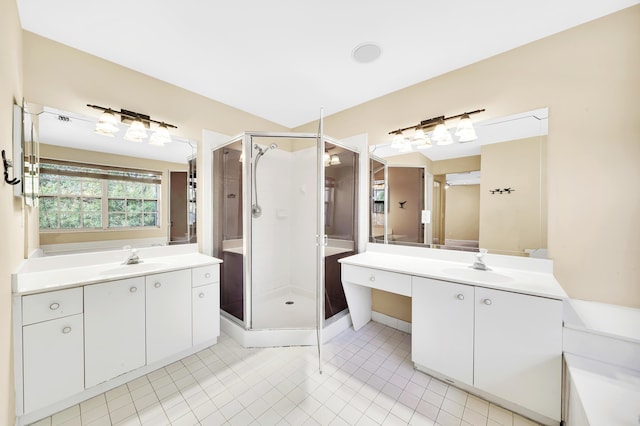 bathroom featuring vanity, tile patterned floors, and a shower with shower door