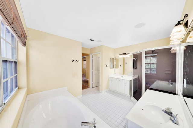 bathroom featuring a tub to relax in, tile patterned floors, and vanity