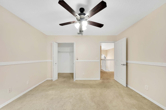 unfurnished bedroom featuring ceiling fan, light colored carpet, and a closet