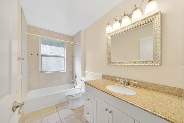 full bathroom featuring tile patterned flooring, vanity, tiled shower / bath combo, and toilet