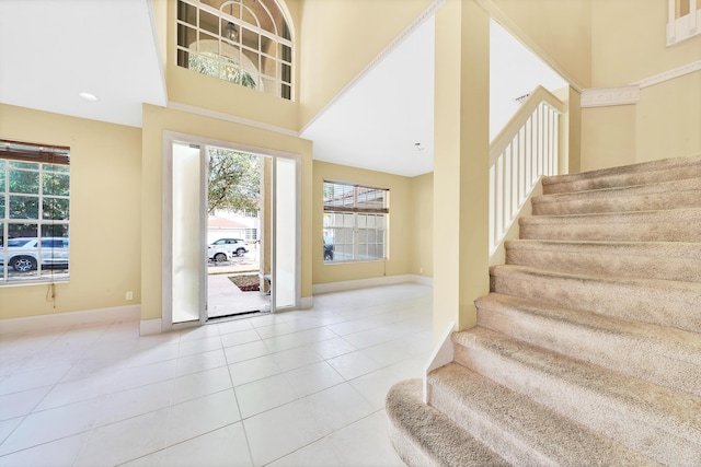 tiled foyer entrance with a towering ceiling