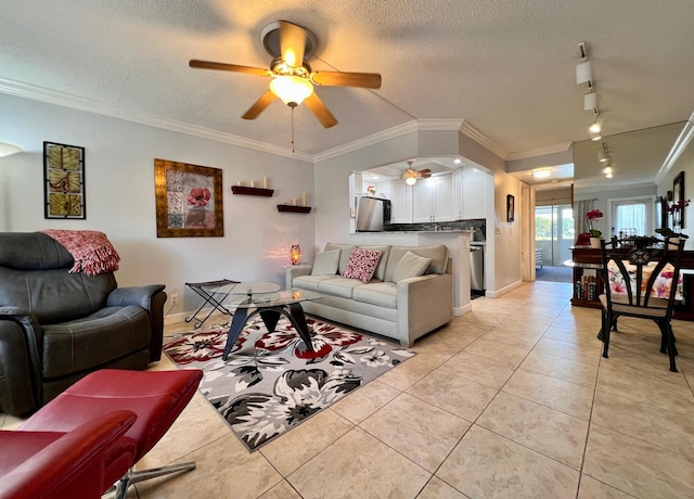 living room with rail lighting, a textured ceiling, light tile patterned floors, ornamental molding, and ceiling fan