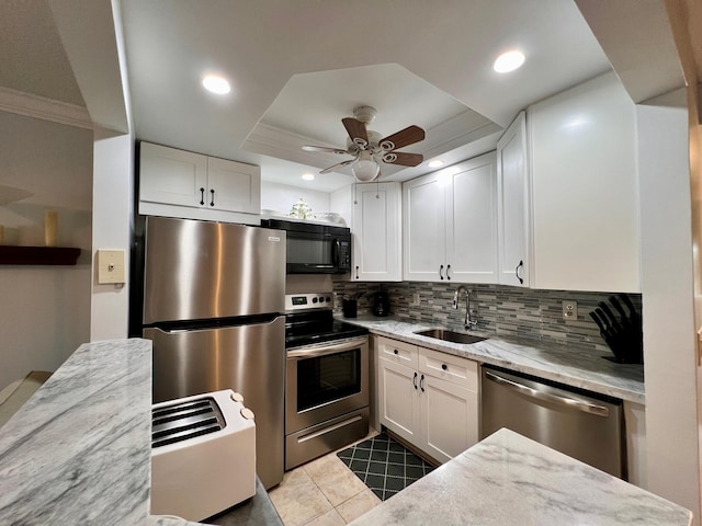 kitchen featuring stainless steel appliances, white cabinetry, light stone countertops, and sink