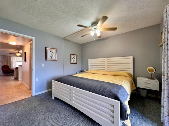 bedroom featuring a textured ceiling, carpet floors, and ceiling fan