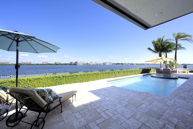 view of swimming pool with a water view and a patio