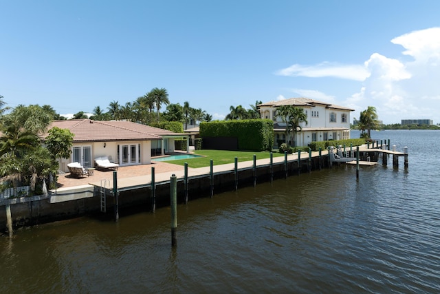 dock area with a yard, a water view, and a patio