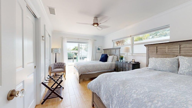 bedroom featuring ceiling fan, light hardwood / wood-style floors, ornamental molding, and multiple windows