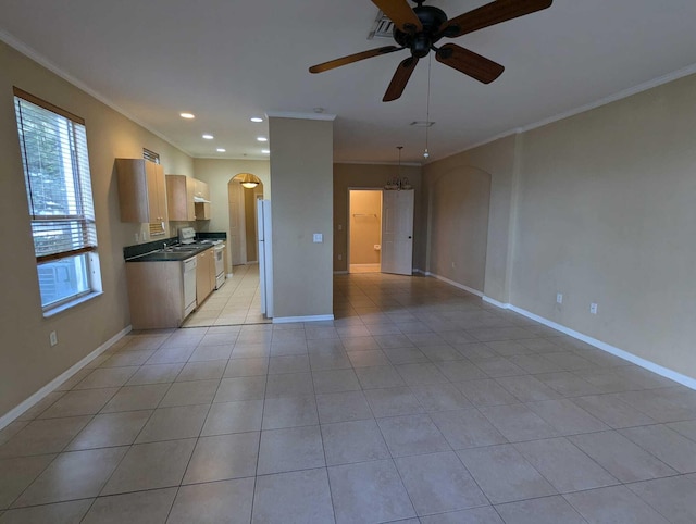 unfurnished living room featuring sink, ceiling fan with notable chandelier, crown molding, and light tile patterned flooring