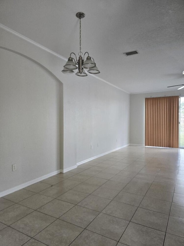 empty room featuring tile patterned flooring, ceiling fan with notable chandelier, crown molding, and a textured ceiling