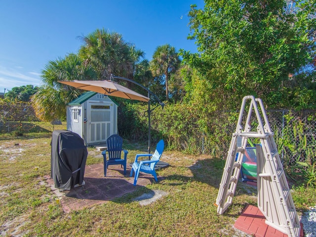 view of playground with a storage unit and a yard