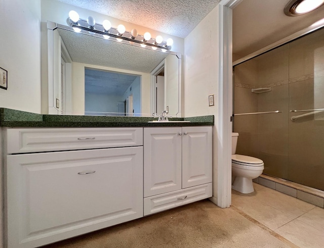 bathroom featuring tile patterned floors, a textured ceiling, vanity, a shower with door, and toilet