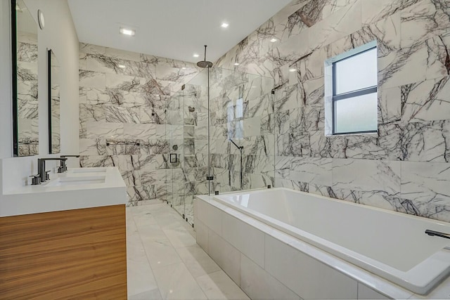 bathroom with vanity, tile walls, and plus walk in shower