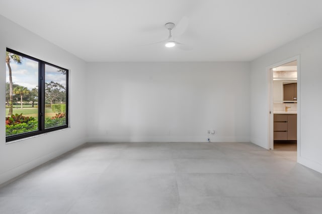 spare room with ceiling fan and a healthy amount of sunlight