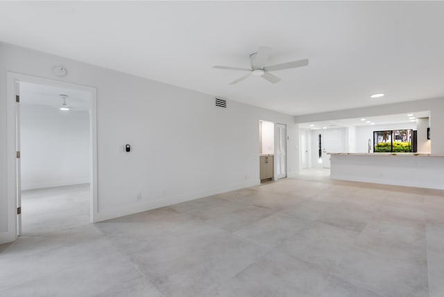 unfurnished living room featuring ceiling fan